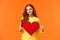 Be my valentine. Lovely gorgeous redhead curly silly girlfriend holding large heart sign and smiling, waiting for