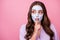 Be quiet, Photo portrait of nice girl with skincare facial mask keeping finger near pouted lips looking at side isolated