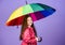 Be rainbow in someones cloud. Rainy day fun. Happy walk under umbrella. Kid girl happy hold colorful rainbow umbrella