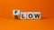 Be slow or in the flow. Turned a cube and changed the word `slow` to `flow`. Beautiful orange background, copy space. Business