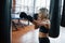 Be stronger every day. Female boxer is punching the bag. Blonde have exercise in the gym