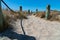 Beach access between rope and bollards across sand path