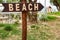 Beach access with wooden beach pointer / sign