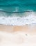 Beach aerial view on the Gold Coast. Nice top view of the blue ocean, crashing wave, white sand and people enjoying a walk.