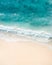 Beach aerial view. Nice top view of the blue ocean, crashing wave and white sand.