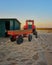 Beach in Ahlbeck with red tractor with trailer. Germany
