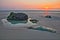 The beach of Ambleteuse at sunset with colorful stones and a fishing net in the foreground, Cote d`Opale, Pas de Calais, Hauts de