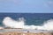 Beach area with a rocky shoreline and waves breaking