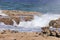 Beach area with a rocky shoreline and waves breaking