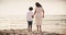 Beach, back and mother holding hands with boy child while walking nature with love, security and freedom. Ocean, travel