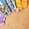 Beach background towel, starfish, flip flops square format sand copy space
