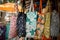 beach bags with different patterns hanging from a market stall