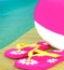 Beach ball and sandals on dock