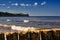 The beach of the Baltic Sea during light wind. There are wooden breakwaters here and on the sandy beach there are numerous small