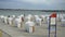 Beach baskets on the Baltic Sea - famous Travemunde beach in Germany - LUBECK CITY, GERMANY - MAY 11, 2021