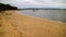 A beach at a bay with boats and tinnies scattered around the water.