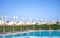 Beach with beach chairs, thatched umbrellas near the pool in Egypt