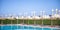 Beach with beach chairs, thatched umbrellas near the pool in Egypt