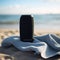 Beach Beats: Black Bluetooth Speaker on Towel with Ocean View