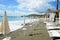 Beach beds and beach umbrellas empty by the sea