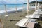 Beach beds and beach umbrellas empty by the sea