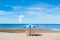 Beach beds and colourful umbrella with ocean horizon view and clear sky slightly clouds in summer