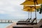 Beach beds lining beside swimming pool near sea