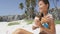 Beach bikini body woman applying sunscreen lotion relaxing on Caribbean vacation