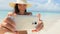 Beach bikini girl taking selfie on phone with smartphone smiling happy