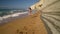 Beach bikini woman carefree running along the water on the beach. Picturesque sea coast of Corfu, Greece. Slow motion