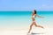 Beach bikini woman carefree running in freedom fun