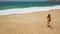 Beach bikini woman carefree running to the water on the beach. Picturesque ocean coast of Portugal