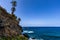 Beach with black volcanic sand, green palm trees on the slope, dangerous waves, Atlantic Ocean, Castro Beach