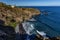 Beach with black volcanic sand, green palm trees on the slope, dangerous waves, Atlantic Ocean, Castro Beach