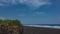 A beach with black volcanic sand on the Pacific coast.