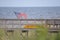 The beach boardwalk stores a kayak and an American flag along the path to the beach