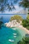 Beach with boats against azure sea in Brela, Makarska, Dalmatia, Croatian coast