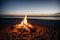 A beach bonfire dwindling down to its last embers
