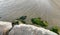 Beach with boulders and rocks covered by algae