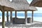 Beach bungalow to relax in front of tropical waters. Tropical vacation background.