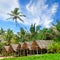 Beach bungalows set against a backdrop of lush tropical vegetation