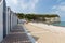 Beach cabins and limestone cliffs near esplanade of Yport, France