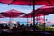 Beach cafe umbrellas and diners enjoy Waikiki Beach resort