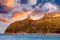 Beach of Cagliari Poetto Sella del Diavolo with Torre del Poetto tower and boats at sunset, Sardinia, Italy