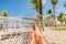 Beach Caribbean travel holiday vacation woman feet selfie lying down relaxing on hammock oustside sunbathing. Girl