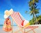 Beach chair with accessories on a tropical beach with palms