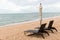 Beach chair and the big umbrella and was on the beach. Beautiful beach. Chairs on the sandy beach near the sea. Summer holiday and