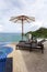 Beach chair in outdoor with swimming pool overlooking view tropical sea