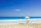 BEACH CHAIR AND UMBRELLA ON IDYLLIC TROPICAL SAND