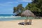 Beach chair and umbrella on idyllic tropical sand beach